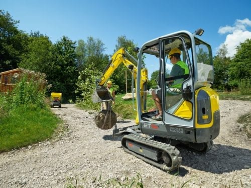 Wacker Neuson ET16 mini Excavator transporting boulder
